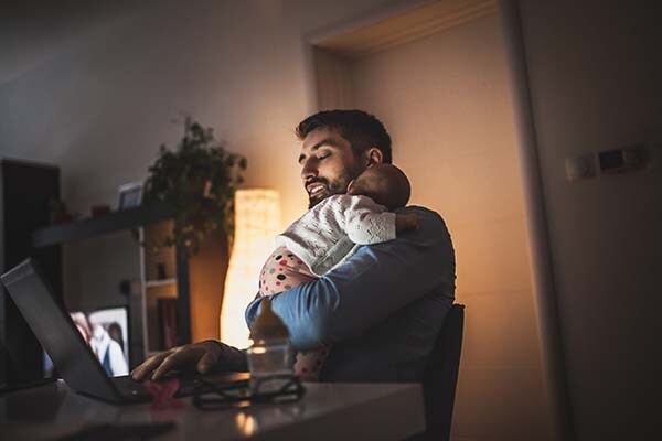 Father working at home with his baby girl